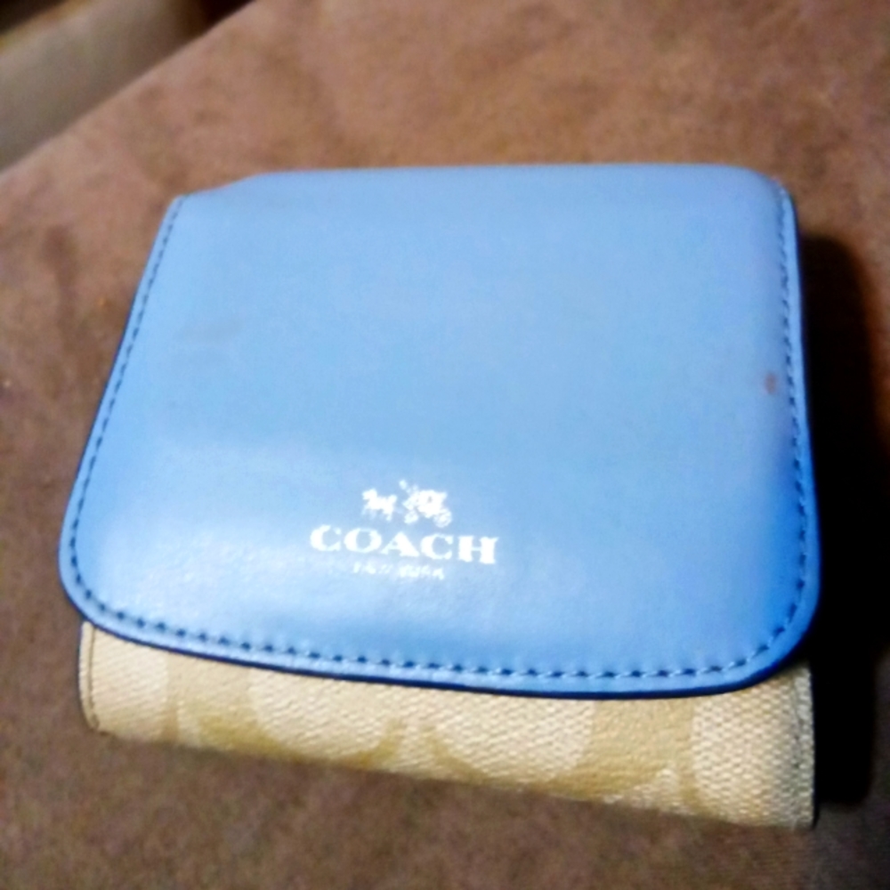 Blue and Coach logo print leather wallet.